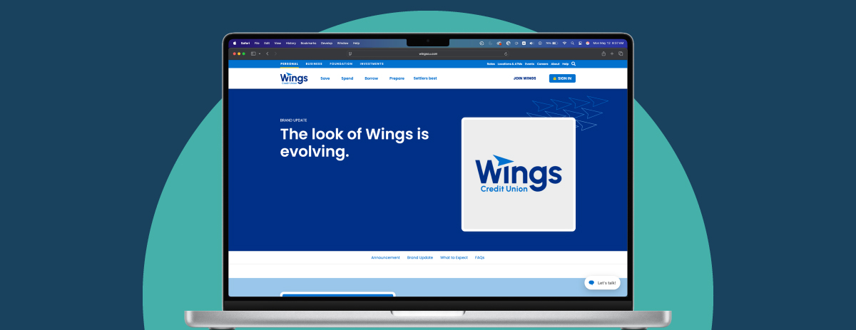 A laptop displaying the Wings Credit Union website with the message “The look of Wings is evolving” and a new logo on the screen.